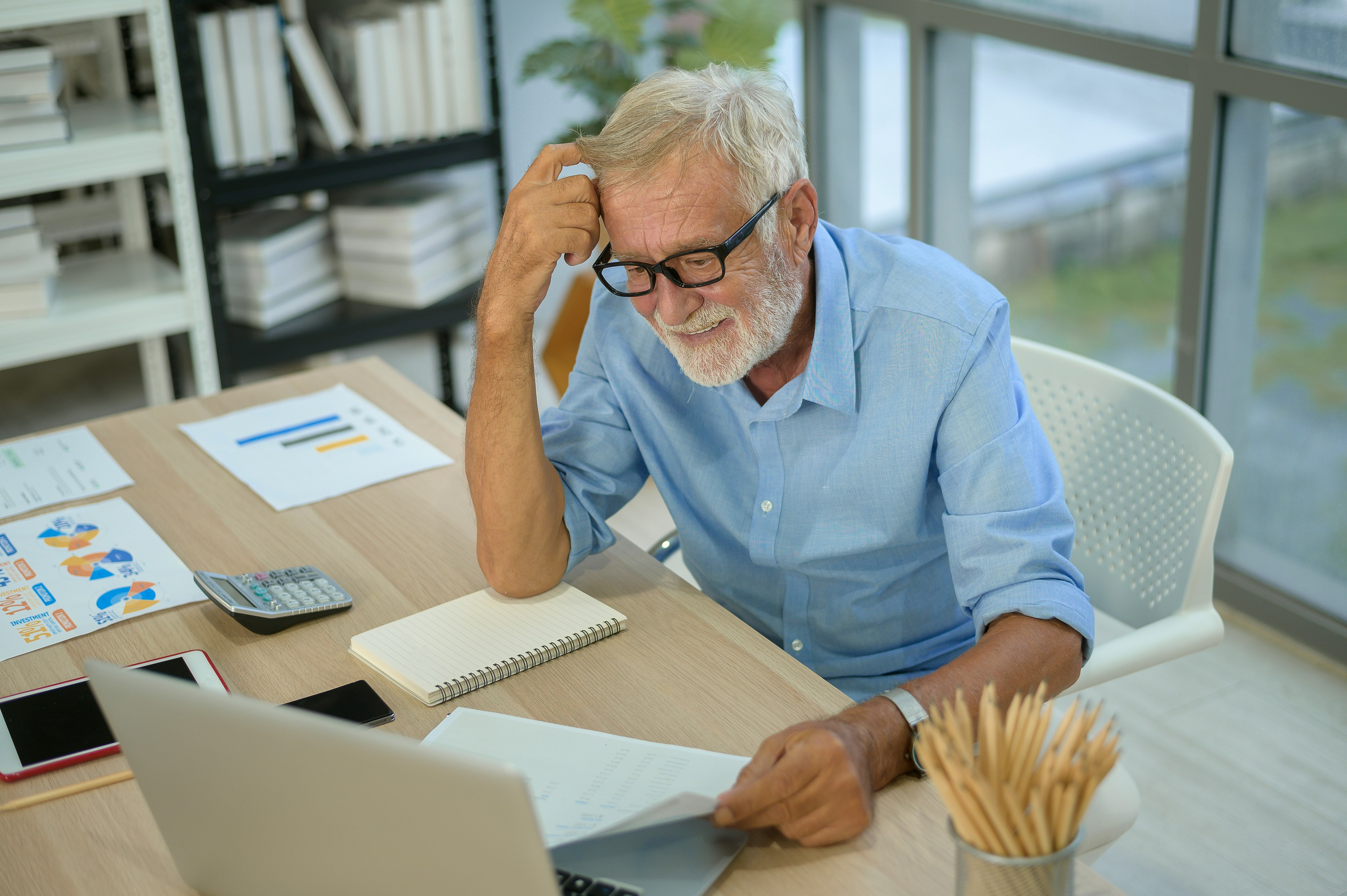 Man looking at retirement accounts on computer